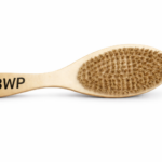 Wooden wave brush close-up with logo